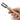 Hand holding a wooden tool with metal components on a white background