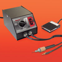 Soldering station with foot pedal and cable on an orange background