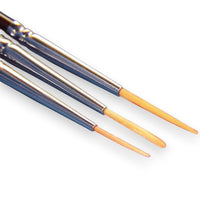Three paintbrushes with wooden handles on a white background