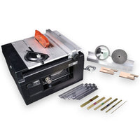 A black and silver table saw accessory kit with a plunge base, orange guard, circular saw blade, grinding wheel, metal guide bars, and several drill bits, photographed on a white background.