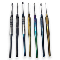Set of dental tools with various colored handles on a white background