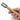 Hand holding a wooden tool with metal components on a white background