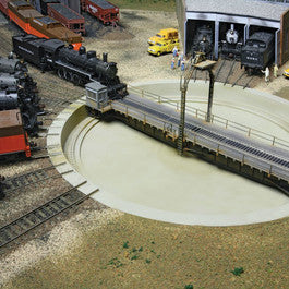 Model train set with tracks and buildings in a miniature layout